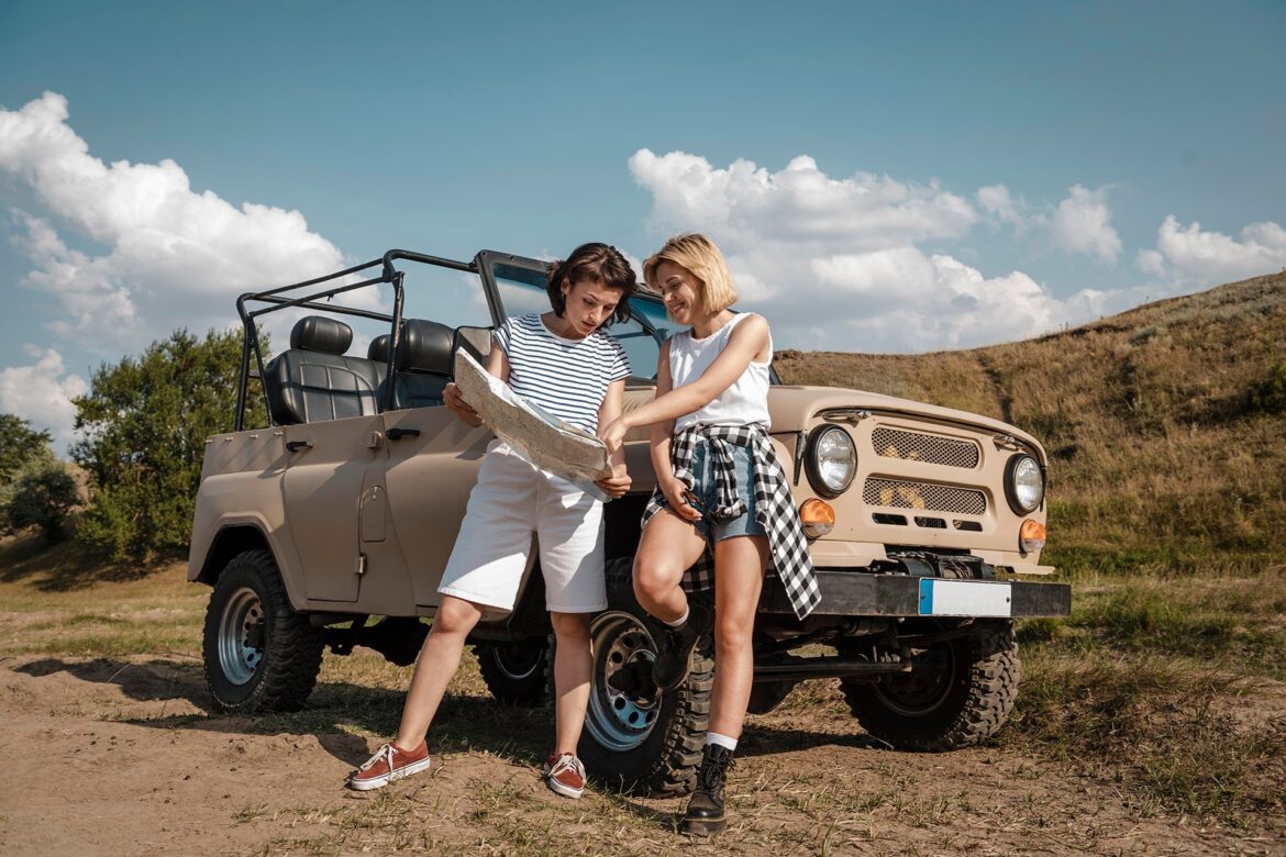 two-women-checking-map-together-while-traveling-by-car
