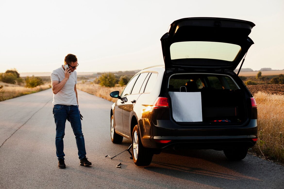 young-man-talking-phone-by-car
